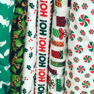 A variety of Christmas flannel fabric bolts